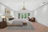 Virtually Staged Bedroom featuring vaulted ceiling, french doors, ornamental molding, access to outside, and recessed lighting
