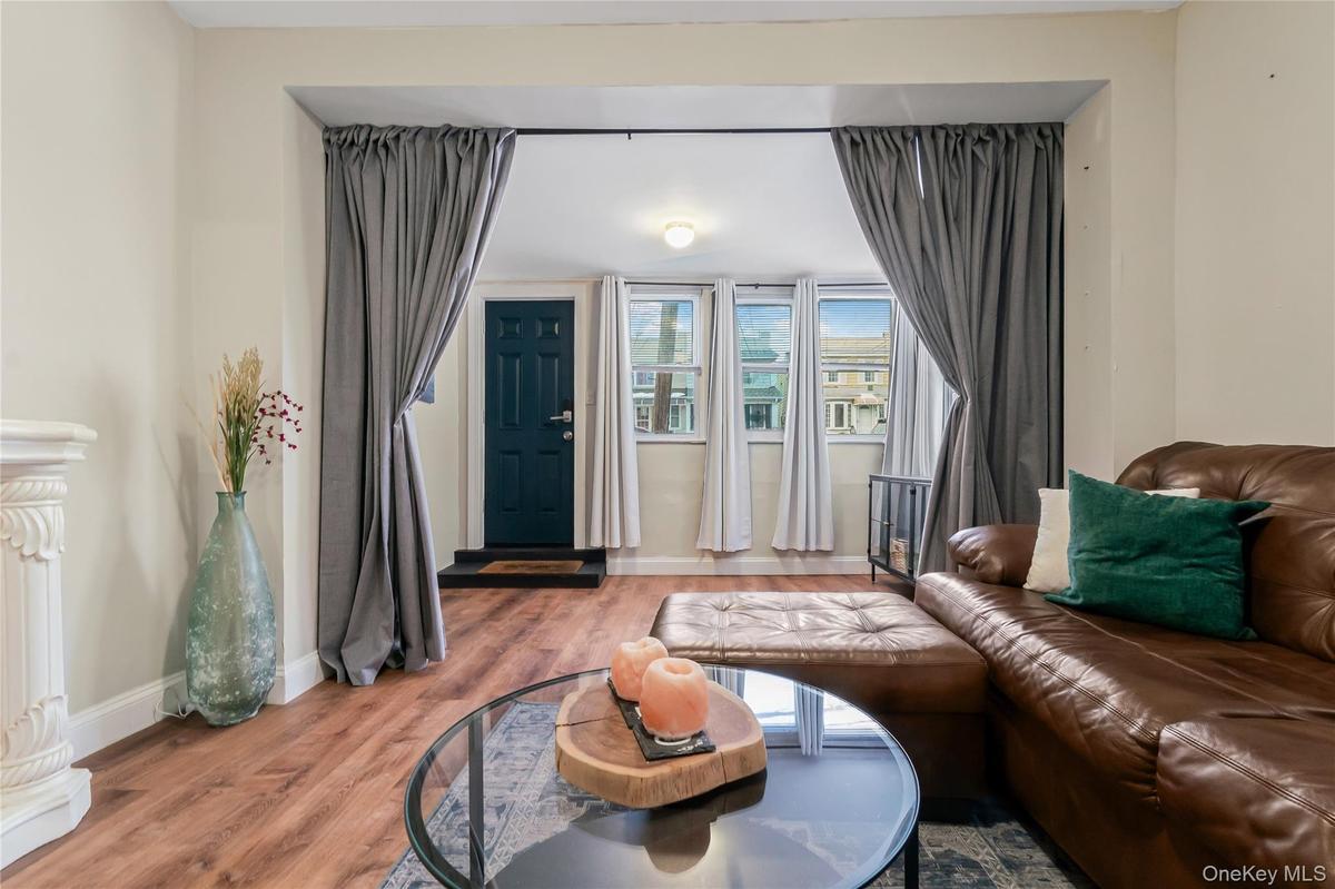 Living area with wood finished floors and baseboards