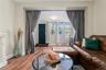 Living area with wood finished floors and baseboards