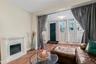 Living room featuring wood finished floors and a glass covered fireplace