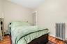 Bedroom featuring radiator, closet, and hardwood floors