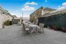 Fenced backyard featuring outdoor dining area and area for grilling . Staged