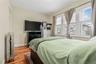 Bedroom with light wood floors and radiator