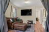 Living area featuring radiator heating unit, wood finished floors, and a fireplace
