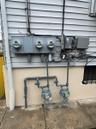 Exterior details with electric meter and gas meter