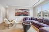 Living room with crown molding and light hardwood / wood-style flooring