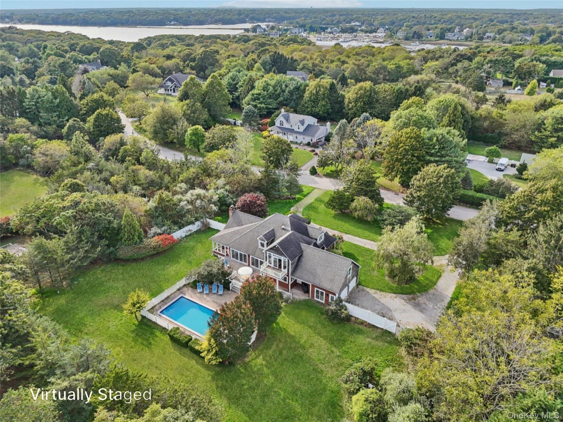 A captivating aerial perspective showcasing the property’s rear elevation, where architecture and landscape blend in perfect harmony. Virtually Staged