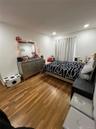 Bedroom with wood finished floors and recessed lighting