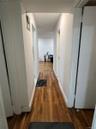 Hallway featuring wood finished floors and baseboards