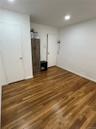 Unfurnished room with hardwood / wood-style floors and recessed lighting
