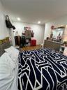 Bedroom featuring dark wood-style floors and baseboards