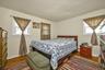 Bedroom with dark wood finished floors