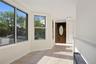 Foyer with baseboards and light tile patterned floors