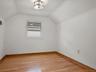Bonus room with baseboards, light wood-style flooring, and vaulted ceiling