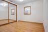 First Fl Unfurnished bedroom featuring visible vents, ornamental molding, a closet, baseboards, and hardwood / wood-style flooring