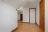 Corridor featuring light wood-style floors, baseboards, and visible vents