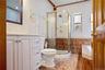 Bathroom with vanity, tile walls, tile patterned flooring, and a stall shower