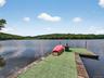 Dock area with a water view and a wooded view