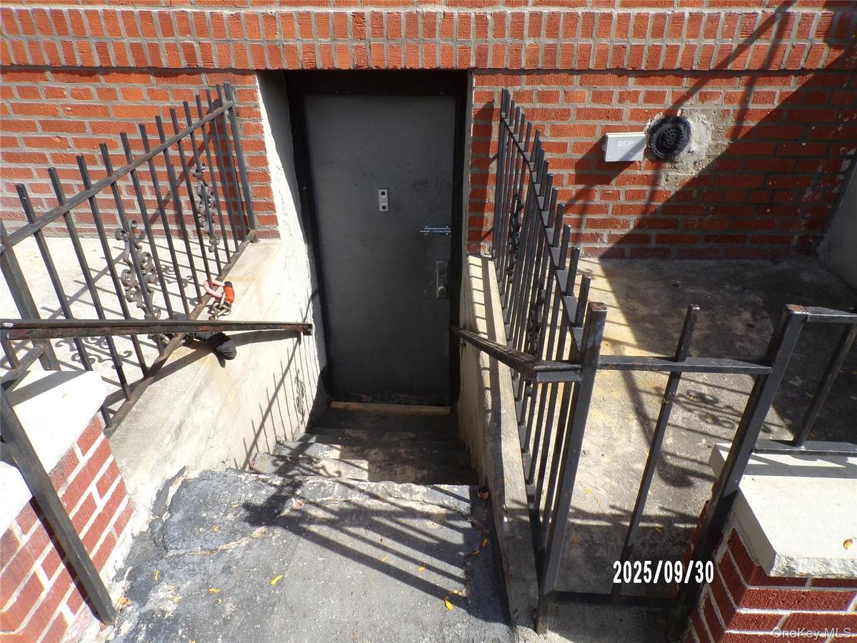 Doorway to property featuring brick siding