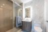 Full bath featuring toilet, tile walls, a stall shower, and vanity