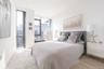 Bedroom featuring floor to ceiling windows and light wood-style floors