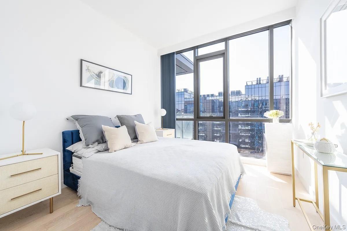 Bedroom with a city view and light wood finished floors