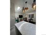 Bedroom featuring a skylight, a chandelier, and dark wood-style flooring
