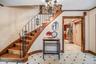 Staircase featuring a chandelier, crown molding, and elevator