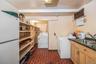 Laundry area with brick patterned flooring and separate washer and dryer