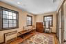 Living area featuring radiator, light wood-style flooring, healthy amount of natural light, and recessed lighting