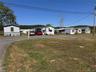 View of grassy yard with asphalt driveway