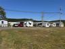 Manufactured / mobile home with a front yard and a residential view