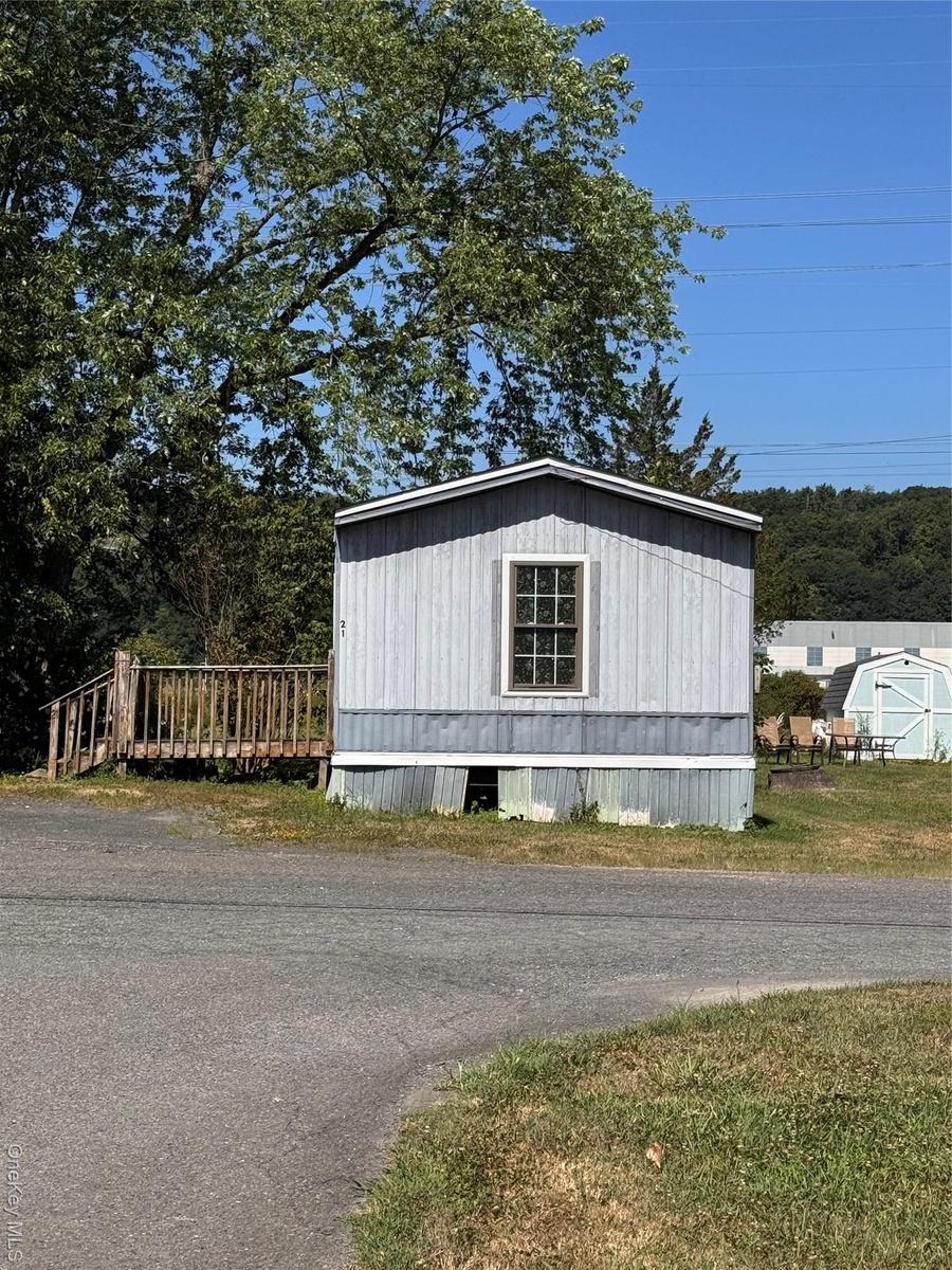 View of property exterior with an outbuilding