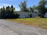 Manufactured / mobile home with entry steps and a front lawn