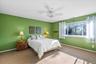 Carpeted bedroom with baseboards and a ceiling fan