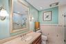 Bathroom with tile walls, a stall shower, vanity, light tile patterned floors, and recessed lighting
