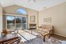 Living room featuring lofted ceiling, carpet floors, and a ceiling fan