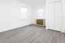 Unfurnished bedroom featuring wood finished floors and a closet