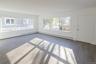 Spare room with baseboard heating and wood finished floors