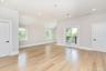Empty room featuring lofted ceiling, healthy amount of natural light, light wood-type flooring, and recessed lighting