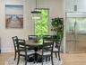 Dining space with light wood finished floors, plenty of natural light, and a chandelier