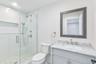 Full bathroom with vanity and a stall shower