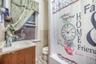 Bathroom with vanity, tile walls, toilet, and tile patterned flooring