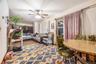 Living room featuring a baseboard heating unit and ceiling fan