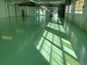 Clear-span industrial floor with perimeter windows and mezzanine access.Natural light, vertical utility, and functional warehouse configuration in one
