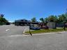 Corner exposure with wraparound access and dedicated parking.Efficient vehicular circulation supporting showroom and warehouse operations.
