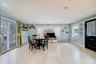 An open-concept kitchen seamlessly connects to a cozy enclosed porch, creating the perfect space for family gatherings and entertaining.