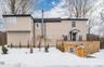 The front of the property features a brick exterior and two separate entrances: one on the main floor and another leading to the basement.
