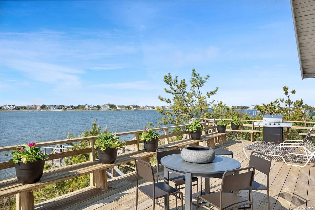 Directly on Moriches Bay, with huge deck, and Atlantic Ocean access across Dune Road