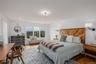 Bedroom with wood finished floors and recessed lighting